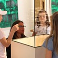Kinder blicken auf Vitrine mit Kunstobjekt
